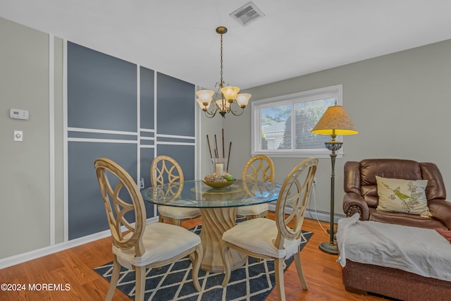 dining room featuring a chandelier and hardwood / wood-style flooring