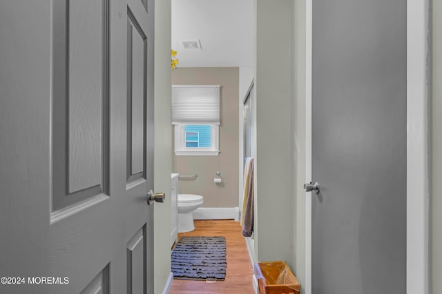 bathroom with toilet and wood-type flooring