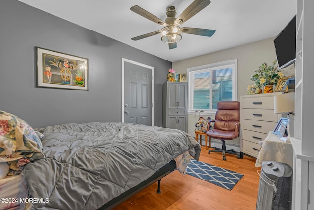 bedroom featuring light wood-type flooring and ceiling fan