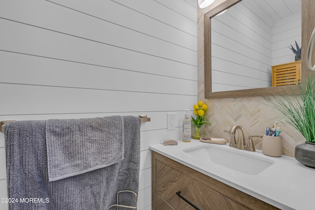 bathroom with vanity and wooden walls