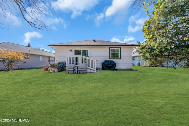 rear view of property with a lawn