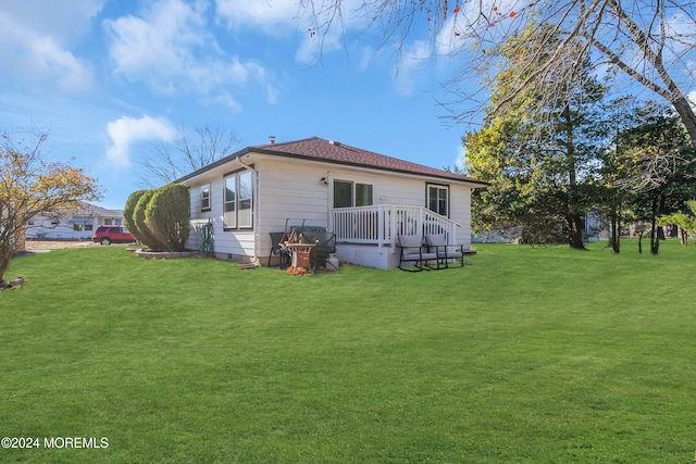 rear view of property featuring a lawn