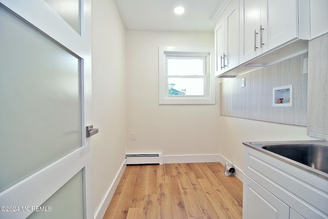 laundry area featuring washer hookup, cabinets, light wood-type flooring, and a baseboard heating unit