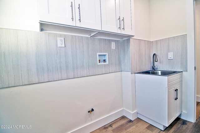 laundry room featuring cabinets, hookup for a washing machine, dark hardwood / wood-style floors, and sink