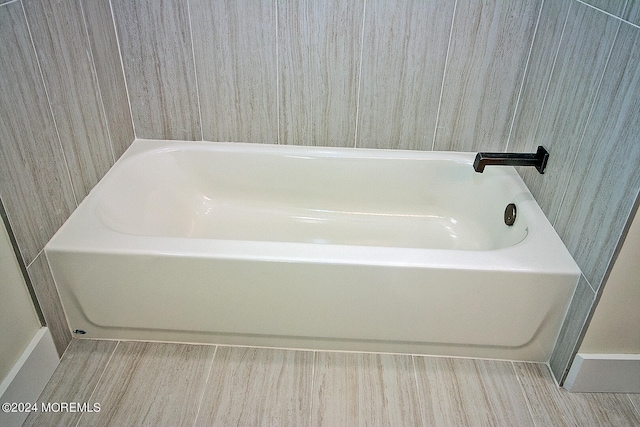 bathroom featuring a bath and wood-type flooring