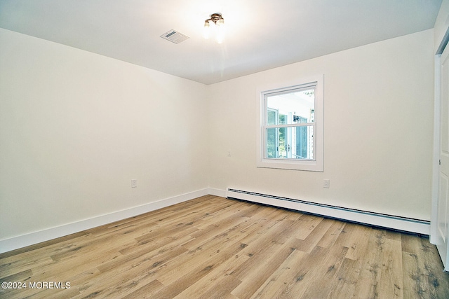 spare room with light hardwood / wood-style floors and a baseboard radiator