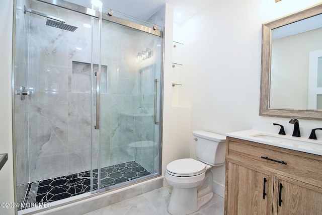 bathroom featuring an enclosed shower, vanity, and toilet