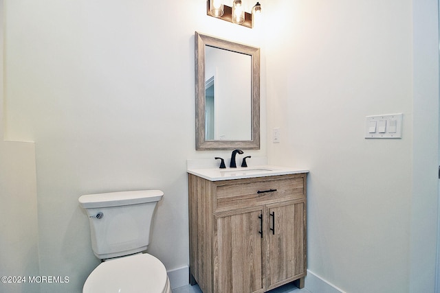 bathroom with tile patterned floors, vanity, and toilet