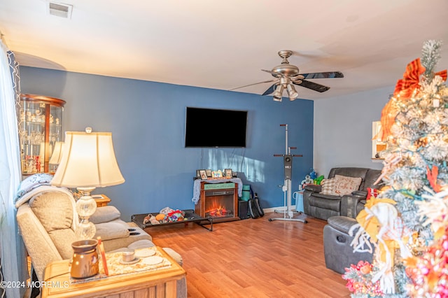 living room with hardwood / wood-style flooring and ceiling fan