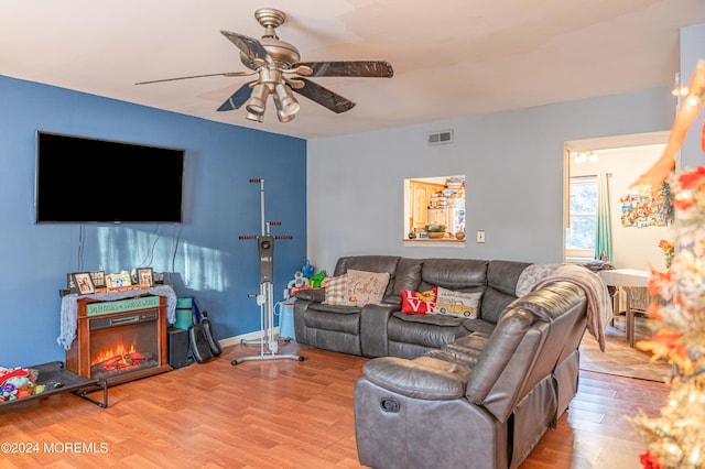 living room with ceiling fan and light hardwood / wood-style floors