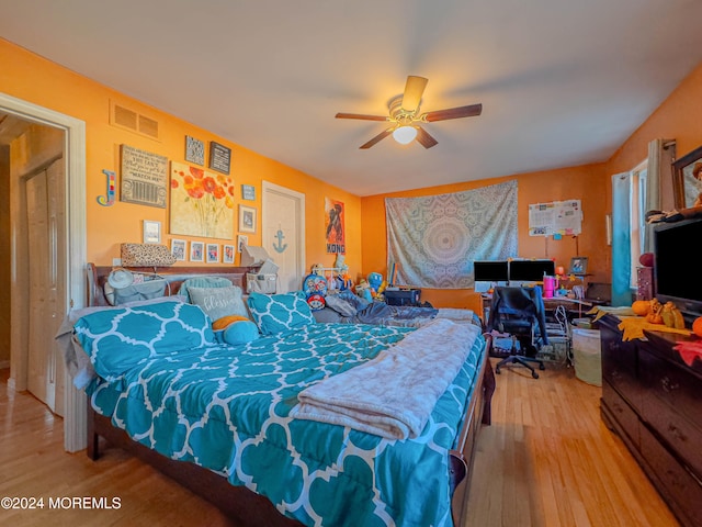 bedroom with hardwood / wood-style floors and ceiling fan