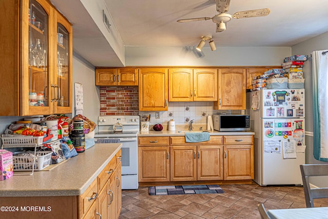 kitchen featuring decorative backsplash, white appliances, ceiling fan, and sink