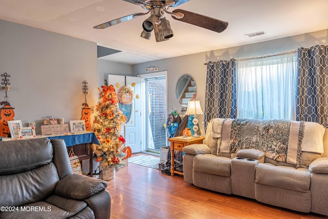 living room with hardwood / wood-style floors, a wealth of natural light, and ceiling fan