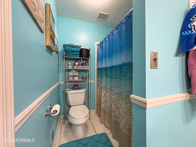 bathroom with tile patterned floors, toilet, and a shower with shower curtain