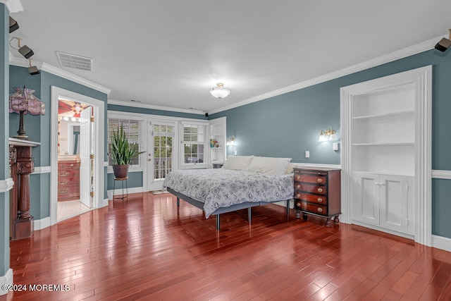 bedroom with connected bathroom, crown molding, and hardwood / wood-style floors