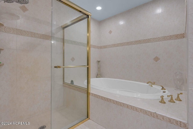 bathroom featuring shower with separate bathtub