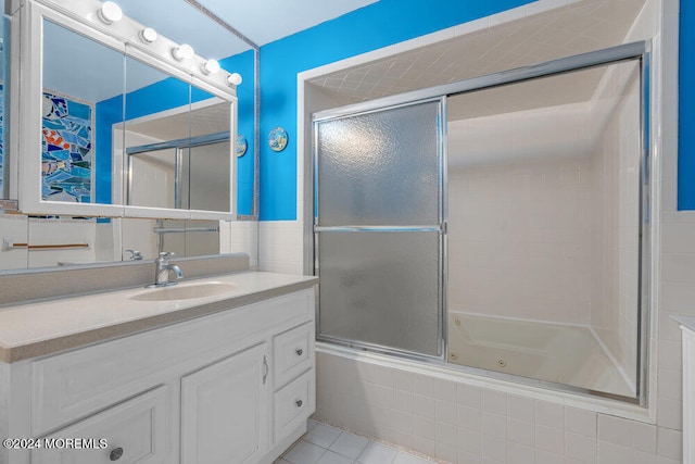 bathroom featuring shower / bath combination with glass door, tile patterned flooring, and vanity