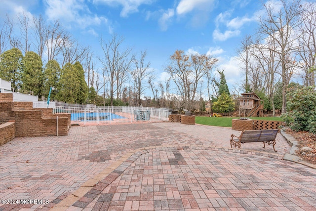 exterior space featuring a playground and a fenced in pool