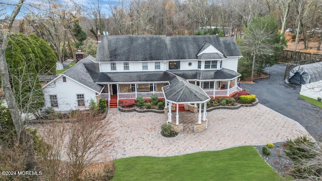 view of front of home featuring a gazebo, a porch, and a front yard