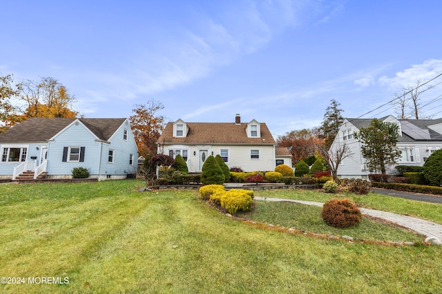 cape cod-style house with a front yard