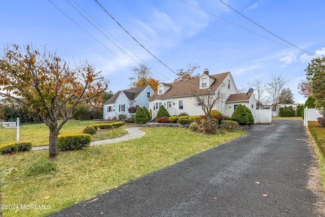 cape cod home with a front yard