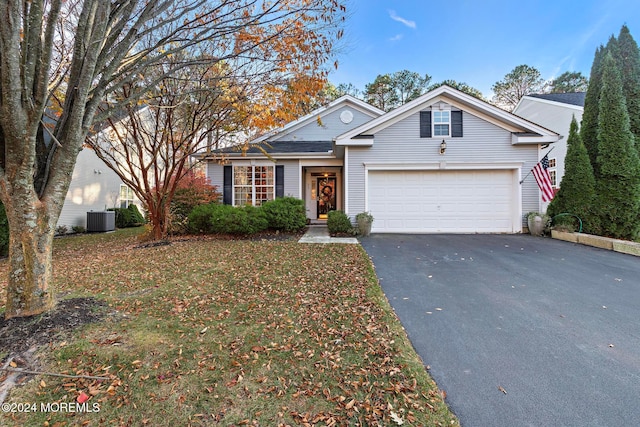 view of front of property with central AC and a garage