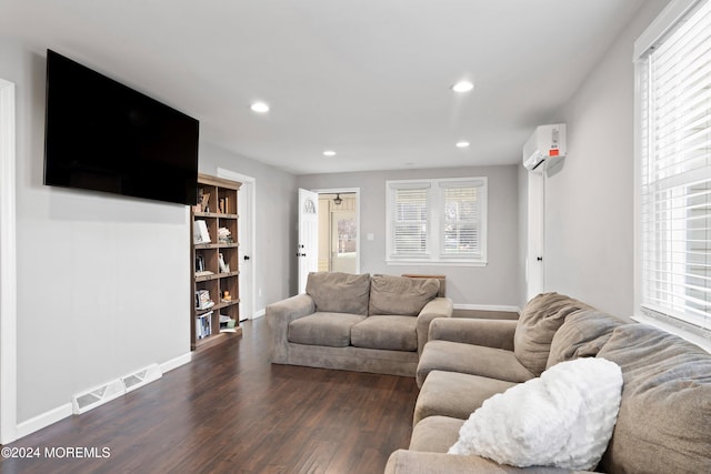 living room featuring dark hardwood / wood-style floors and a wall mounted AC