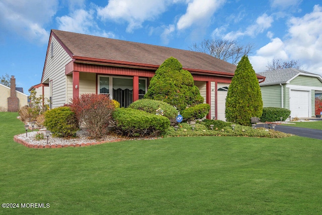 view of front of home with a garage and a front lawn