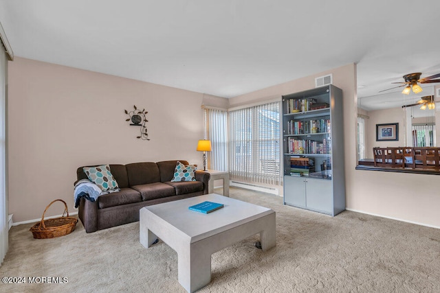 living room featuring ceiling fan, carpet floors, and a baseboard radiator