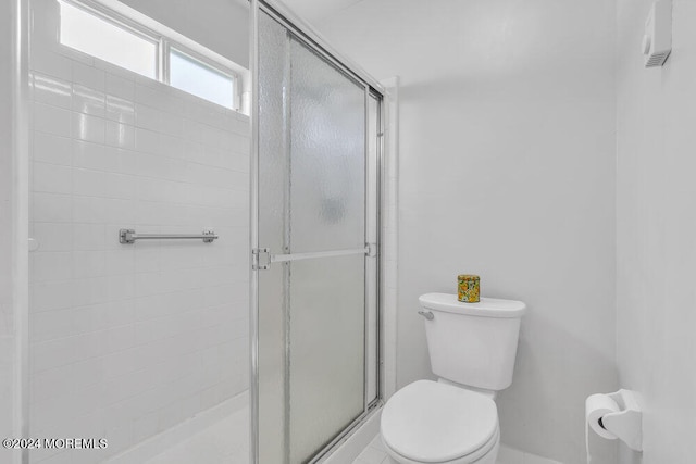 bathroom with walk in shower and toilet