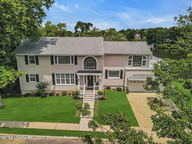 404 Ocean Rd, Spring Lake, NJ 07762 - view of front facade with an attached garage, a front lawn, driveway, and a shingled roof