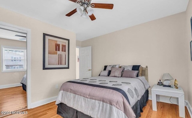 bedroom with ceiling fan and light hardwood / wood-style floors