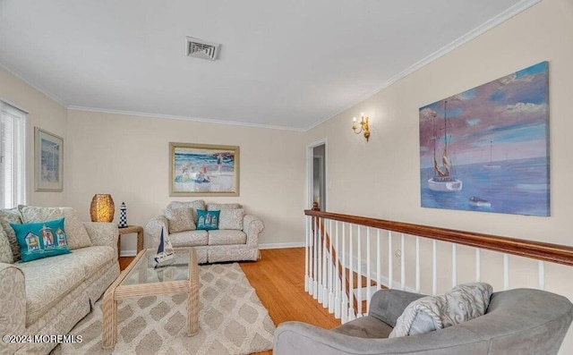 living room featuring hardwood / wood-style flooring and ornamental molding