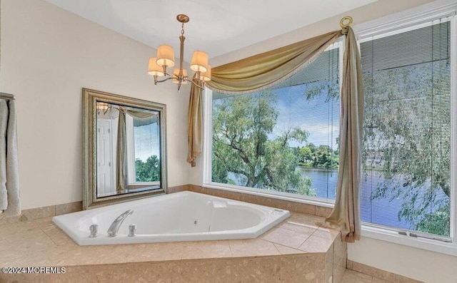 bathroom featuring tile patterned floors, a water view, tiled tub, and a chandelier