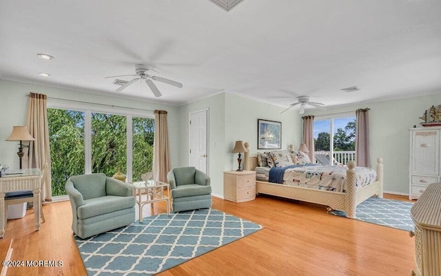 bedroom featuring ceiling fan, crown molding, light hardwood / wood-style flooring, and multiple windows