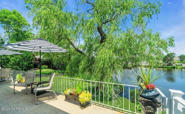 view of patio with a water view