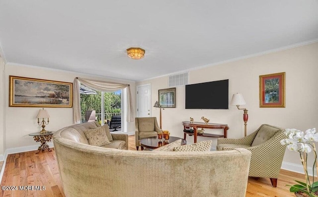 living room with light wood-type flooring and crown molding