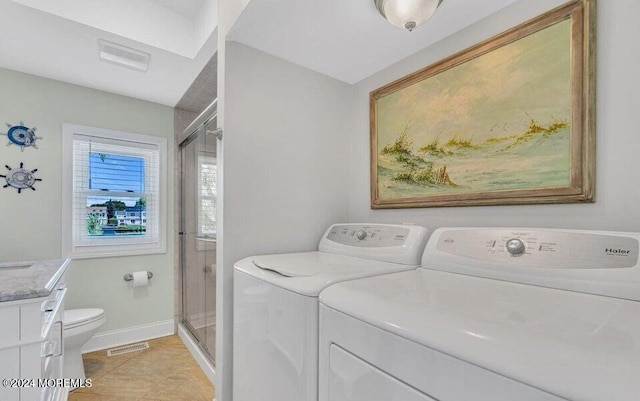 404 Ocean Rd, Spring Lake, NJ 07762 - laundry area featuring washer and clothes dryer, light tile patterned flooring, and baseboards