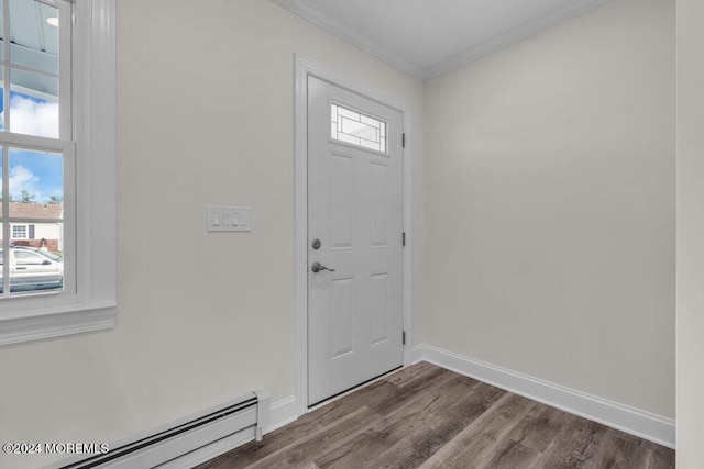 foyer featuring hardwood / wood-style floors, crown molding, and a baseboard heating unit