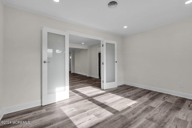 unfurnished room with french doors and wood-type flooring