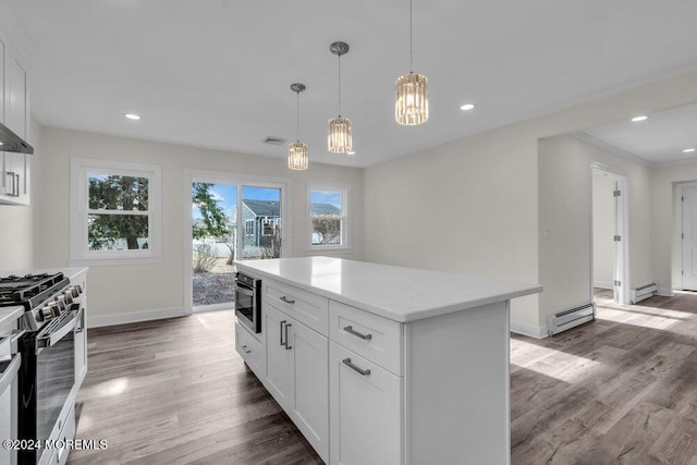 kitchen featuring a wealth of natural light, white cabinetry, and appliances with stainless steel finishes