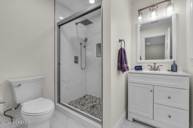 bathroom featuring toilet, vanity, and walk in shower