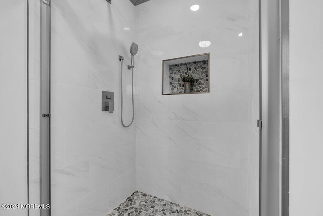 bathroom with a tile shower