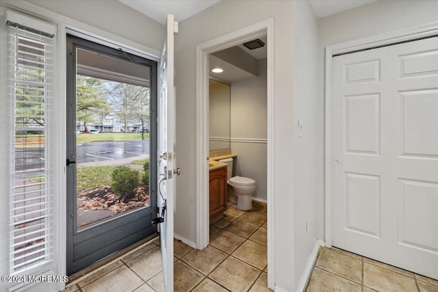 bathroom with tile patterned floors, vanity, and toilet