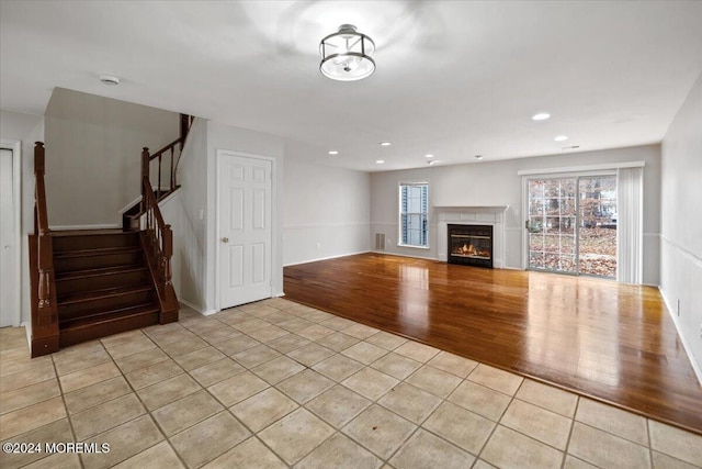 unfurnished living room with light tile patterned floors