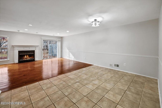 unfurnished living room with light tile patterned floors