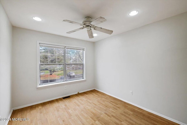 unfurnished room with ceiling fan and light wood-type flooring