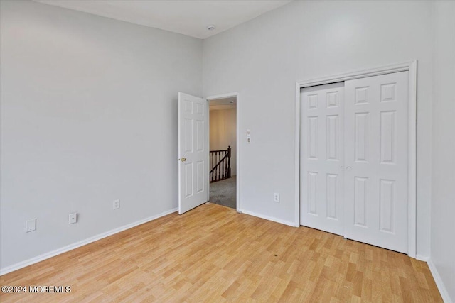 unfurnished bedroom featuring a closet and light hardwood / wood-style floors