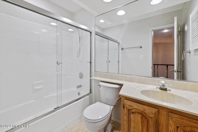 full bathroom with vanity, bath / shower combo with glass door, and toilet