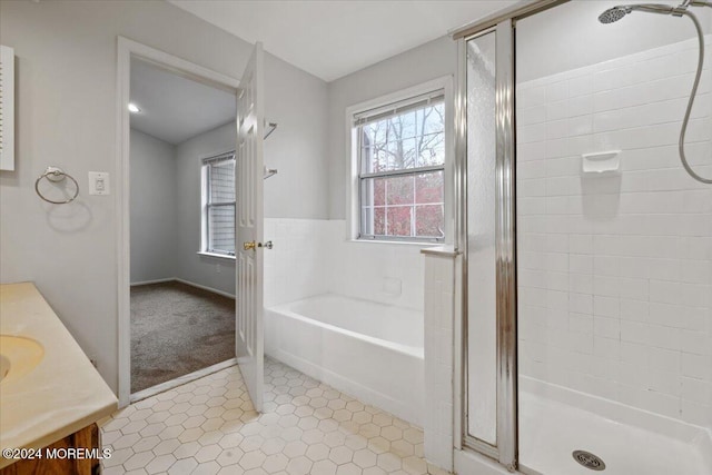 bathroom featuring vanity and shower with separate bathtub